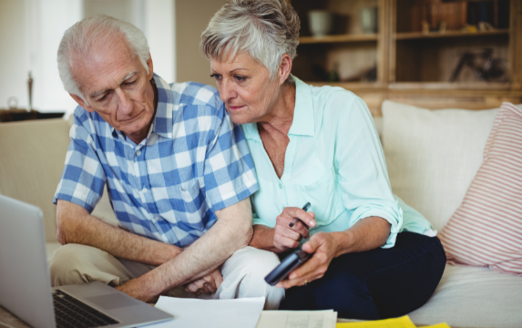 Baby Boomer couple worried about their financial wellness.