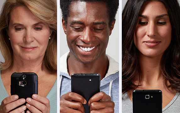 Diverse set of people looking at their cell phones