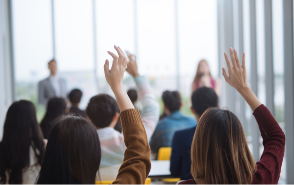 Employees engaged and asking questions during benefits presentation