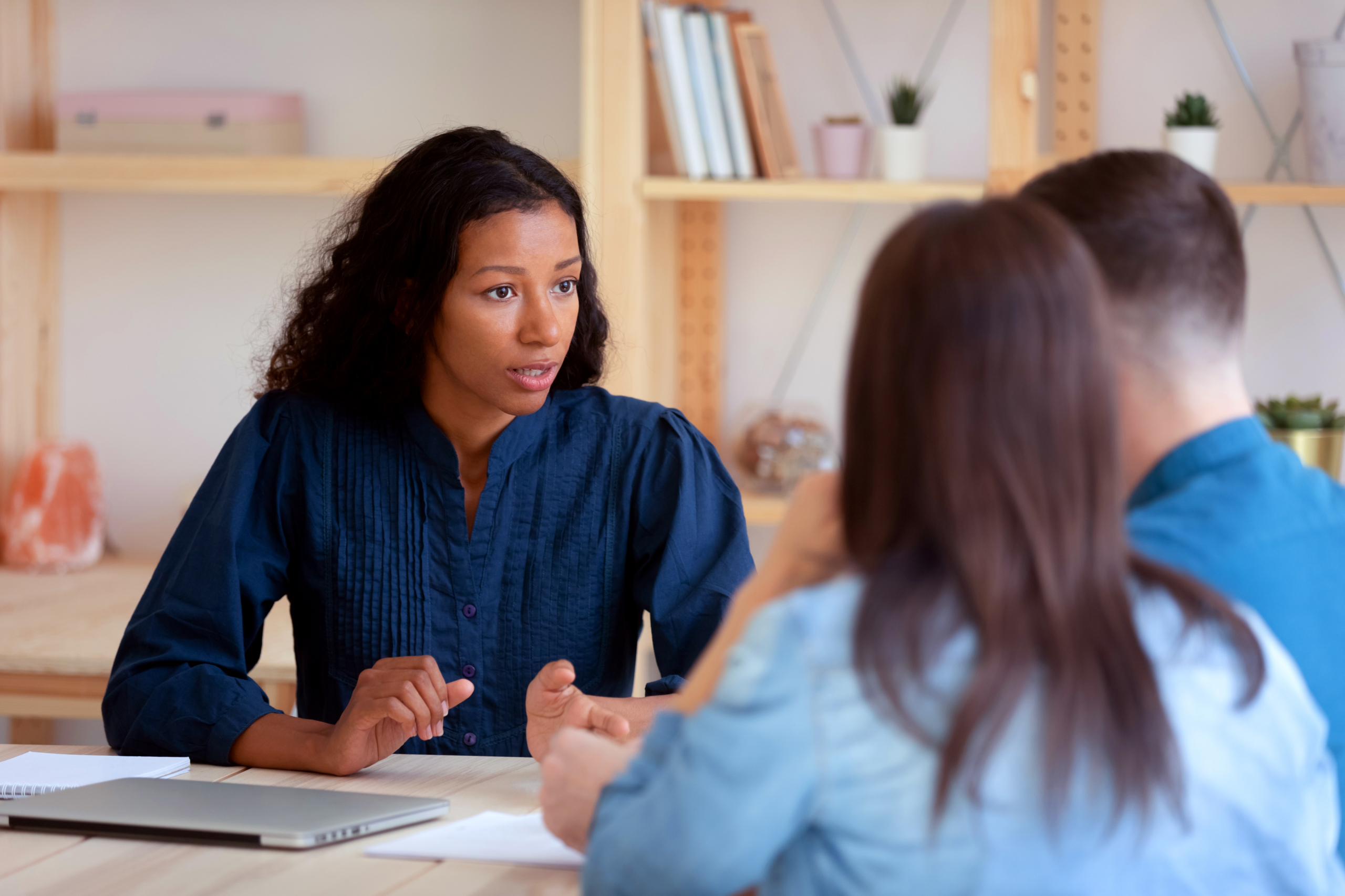 A financial advisor speaks with clients about their financial plan.