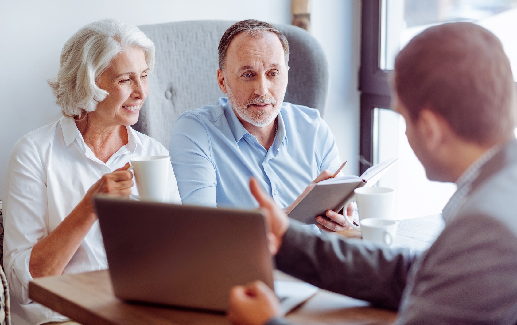 A retired couple speaks to a financial advisor.