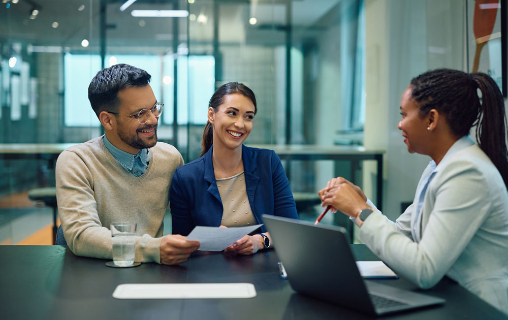 A financial advisor conducting an investment review meeting with clients.