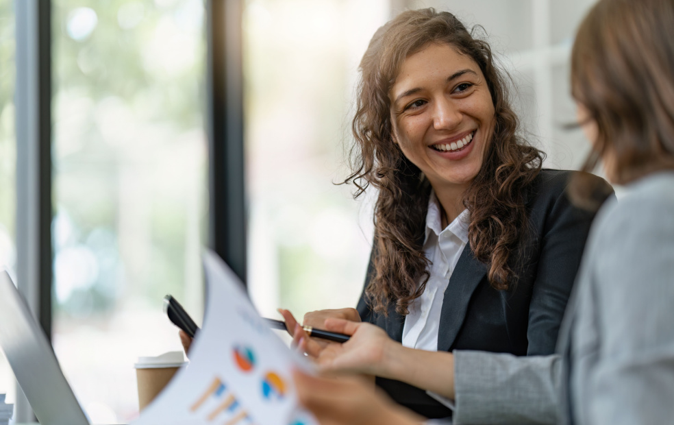 Smiling recruiter talking to financial advisor in interview