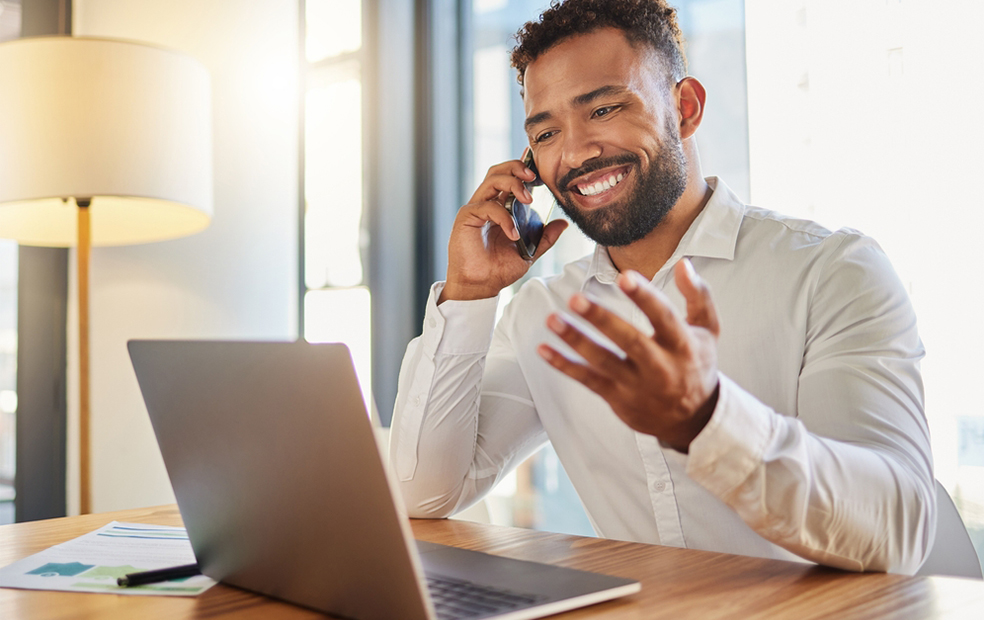 A financial advisor talking on the phone with a potential client