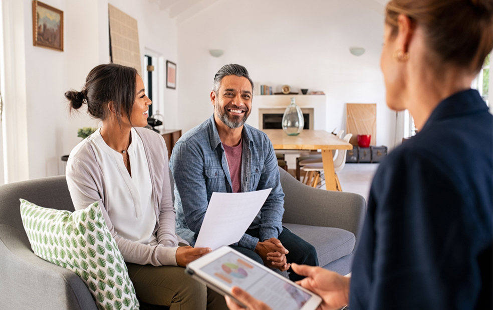 Female financial planner helps couple to personalize their financial plan.