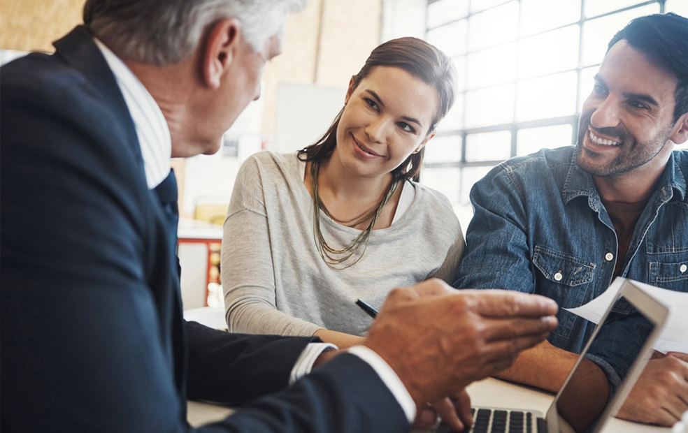 A financial advisor speaks to a couple.