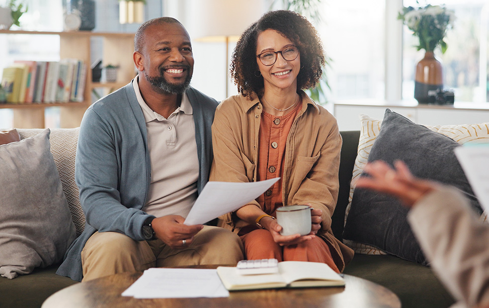 Mature couple collaborating with financial advisor