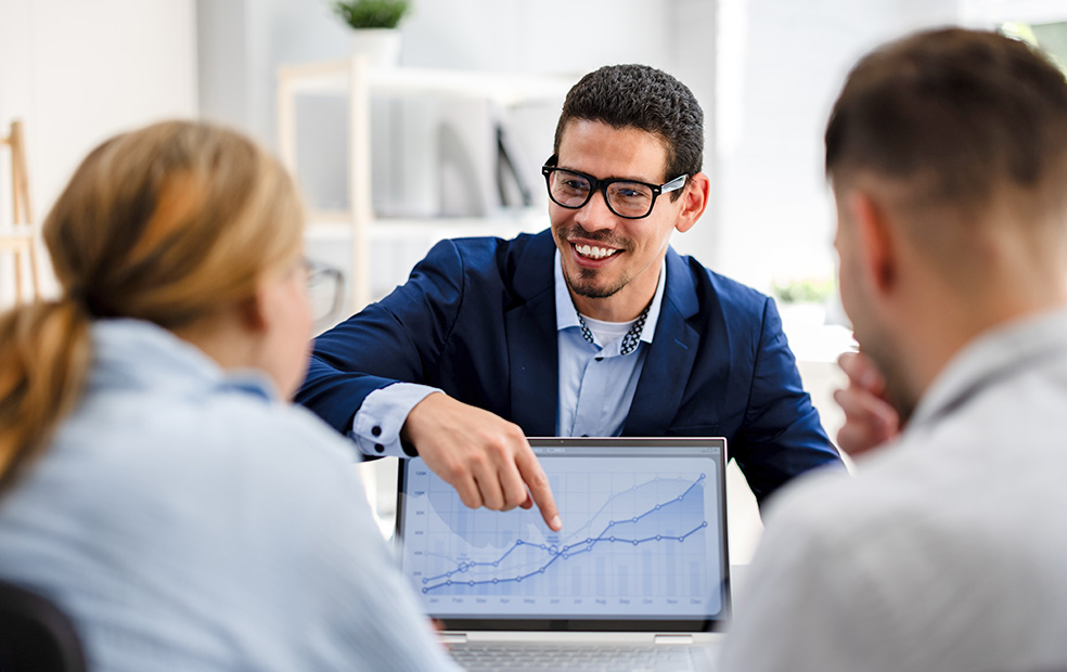 An advisor conducting an annual review meeting with clients.