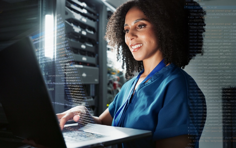 Woman at computer in server room