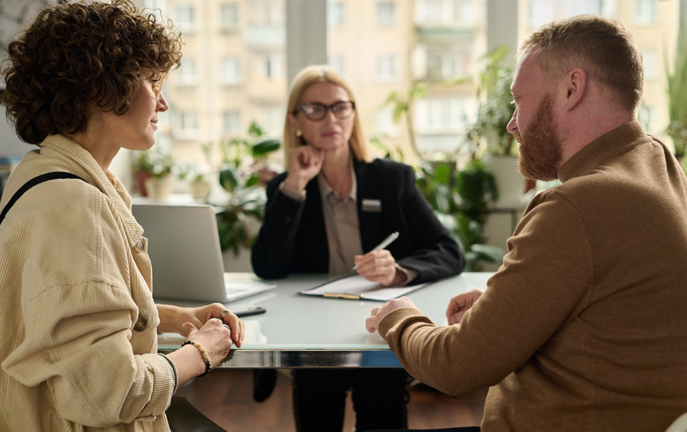 A financial planner meeting with a couple.