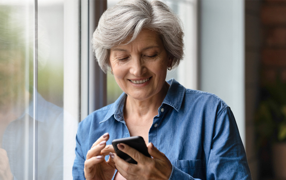 Older female client receives mobile communication