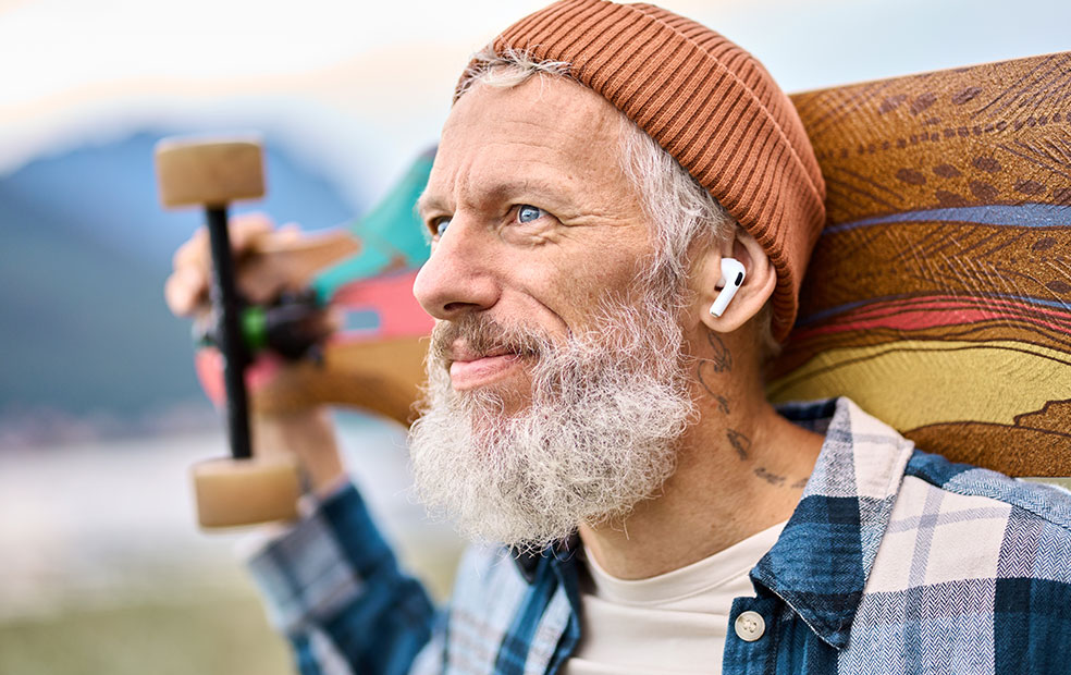 Hip older man with beard and skateboard