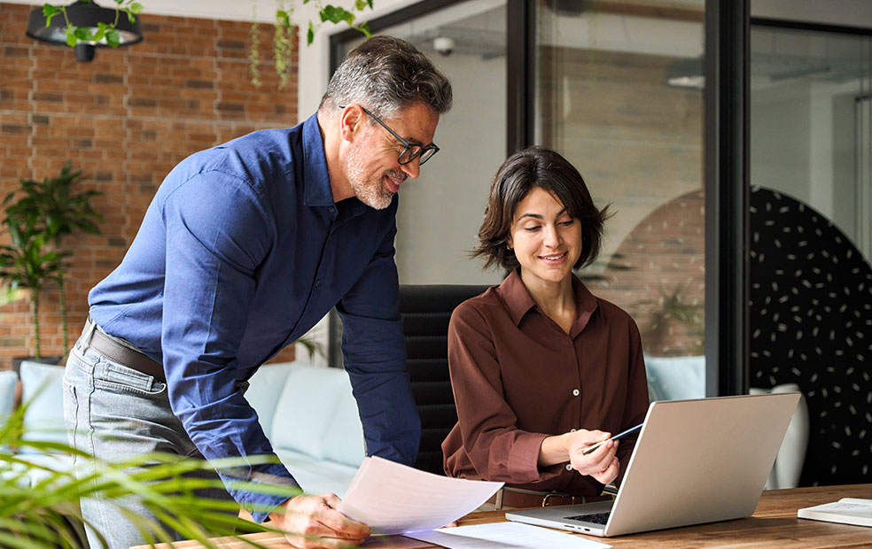 Two financial professionals talking about a project.