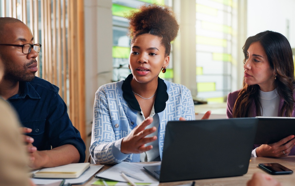 Three coworkers having a meeting.