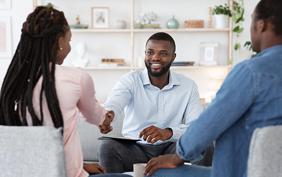 Financial advisor sitting down for meeting with couple