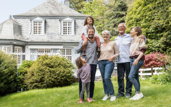 Multi-generational family in front of family home