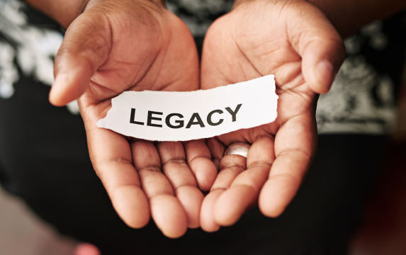 Hands holding paper that says Legacy