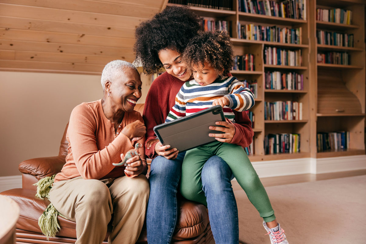 family enjoying time together at home on a tablet