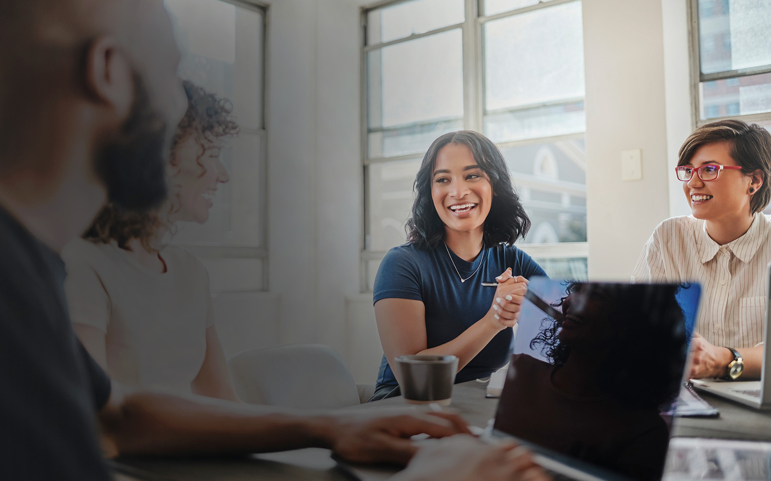 happy team in a meeting at a table