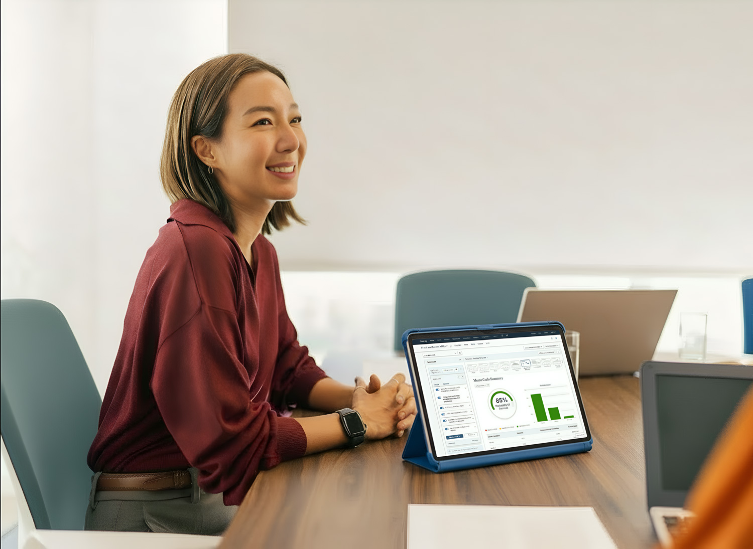 person happily presenting with coplanner on ipad